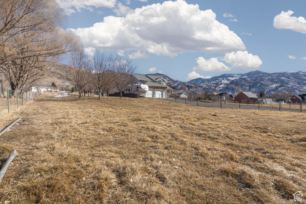 View of yard featuring fence and a mountain view