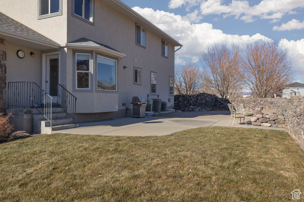 View of yard featuring cooling unit and a patio