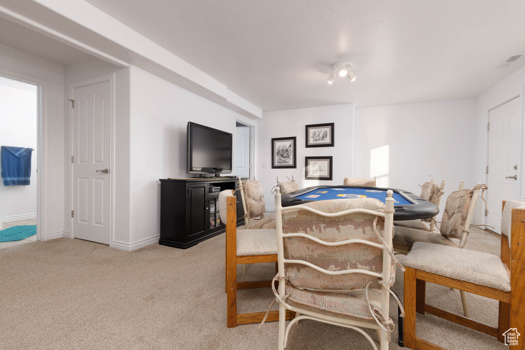 Carpeted dining area featuring visible vents and baseboards