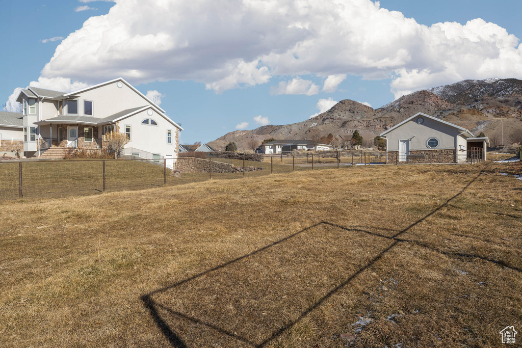 View of yard featuring fence private yard, a rural view, and a mountain view