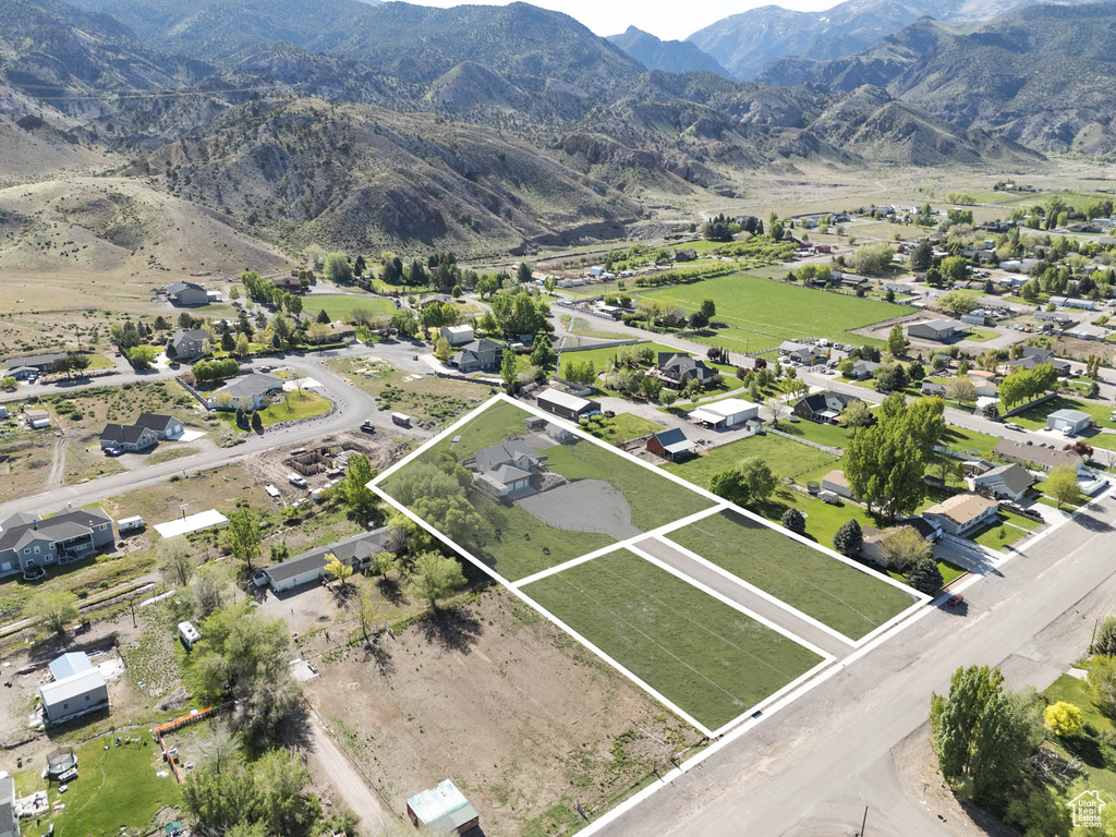 Aerial view of property's location with property parcel outlined and a mountainous background