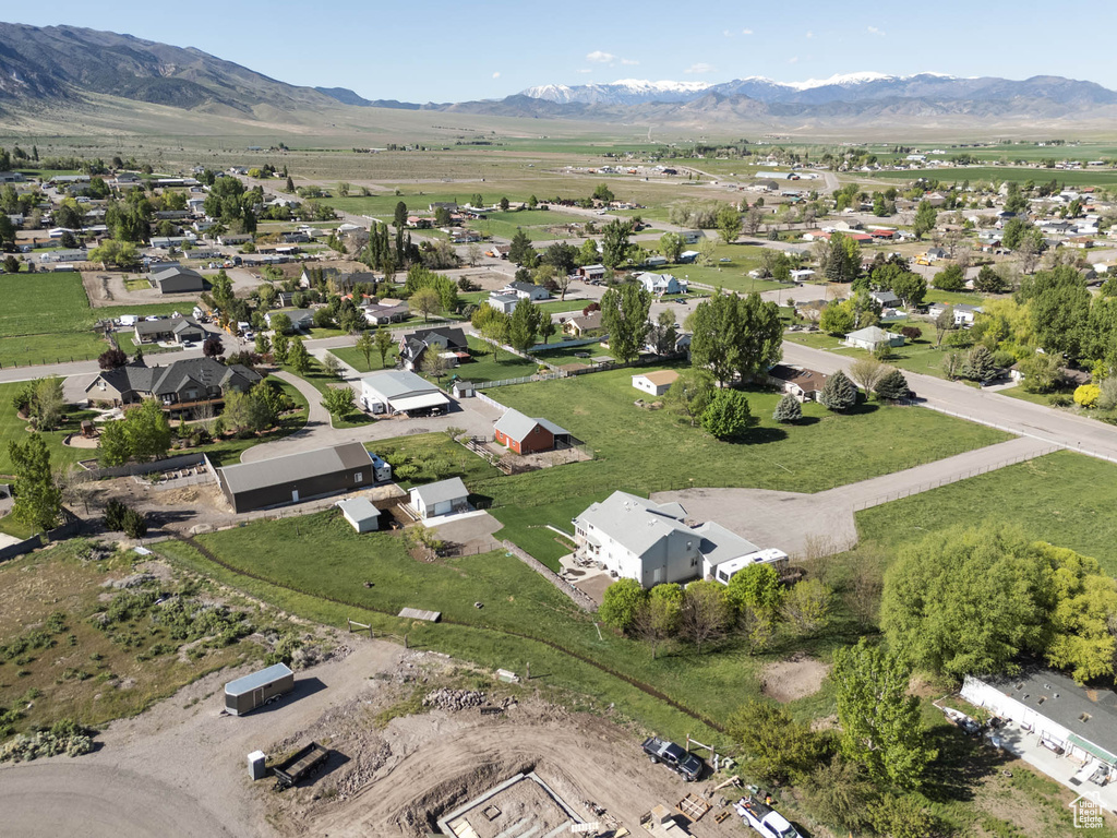 Aerial view of property's location featuring mountains and nearby suburban area
