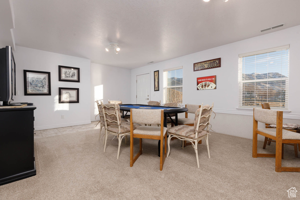 Dining area with light colored carpet and visible vents