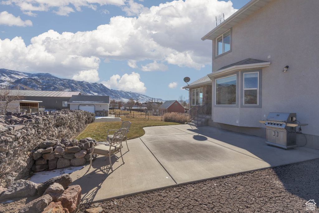 View of patio with grilling area and a mountain view