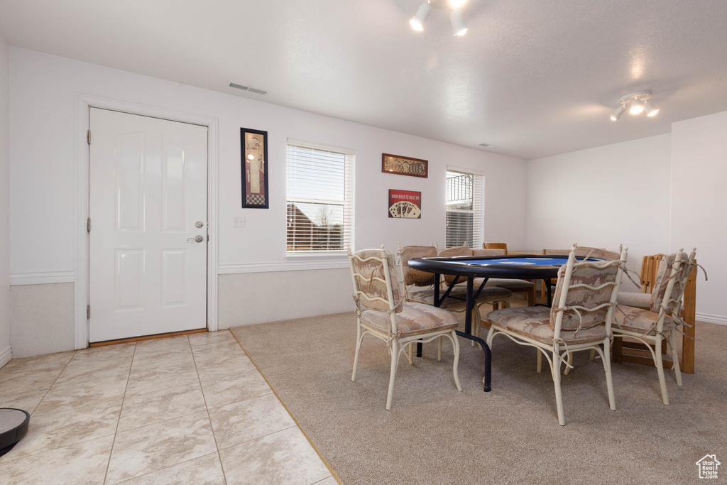 Dining area with visible vents and light tile patterned flooring