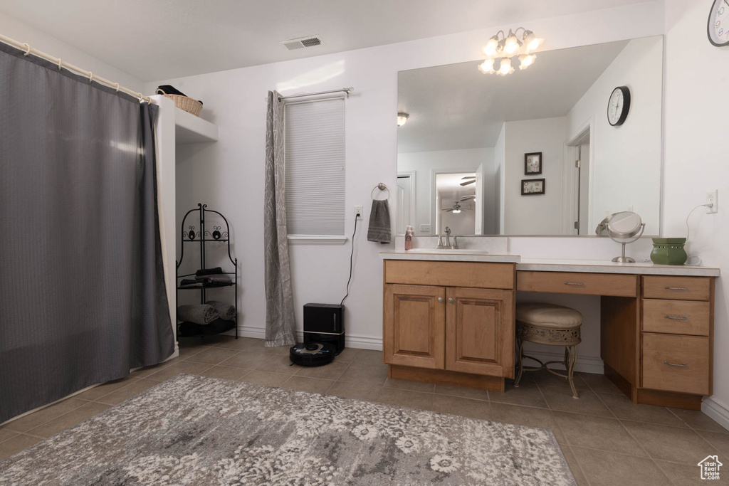 Bathroom featuring a notable chandelier, visible vents, vanity, baseboards, and tile patterned floors