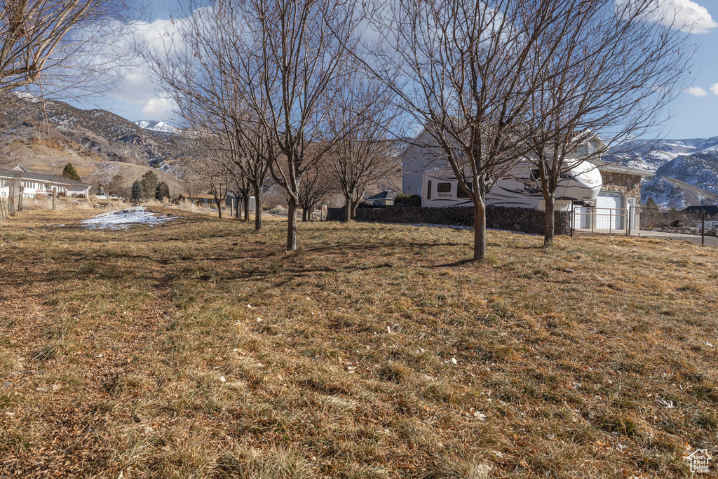 View of yard featuring fence and a mountain view