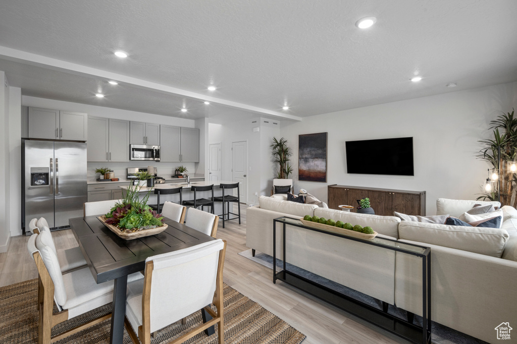 Dining space featuring light wood finished floors and recessed lighting