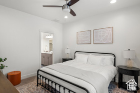 Carpeted bedroom featuring a ceiling fan, recessed lighting, baseboards, and ensuite bathroom