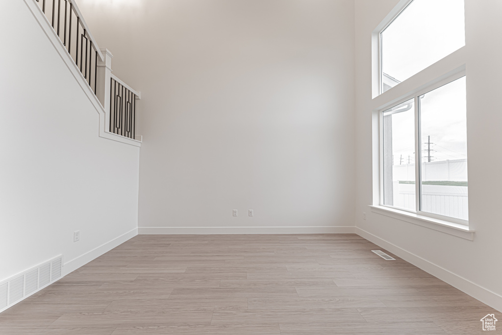 Unfurnished room featuring light wood-style flooring and baseboards