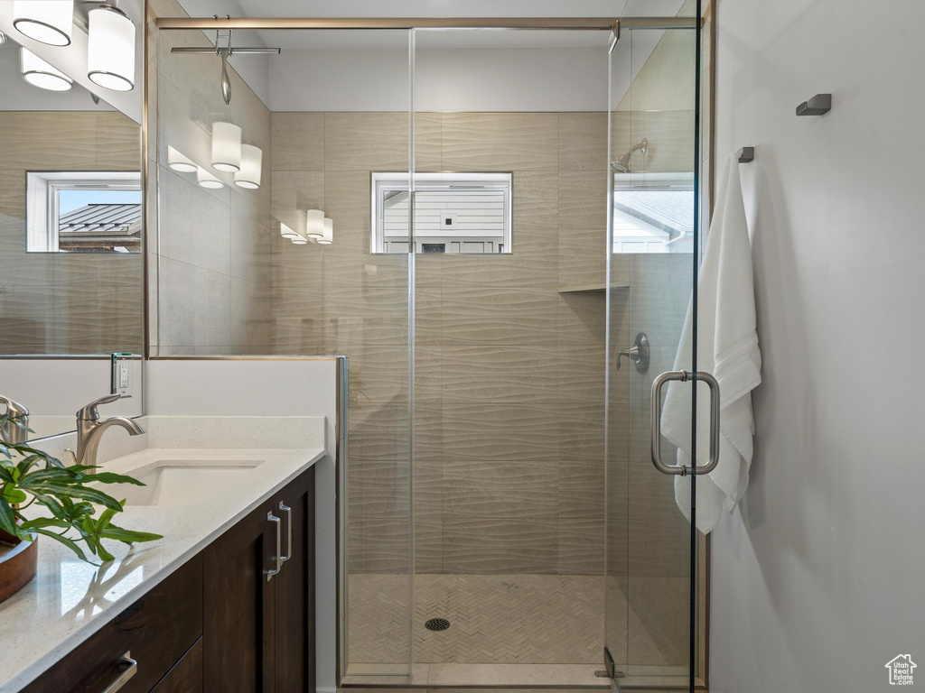 Full bath featuring a shower stall and vanity