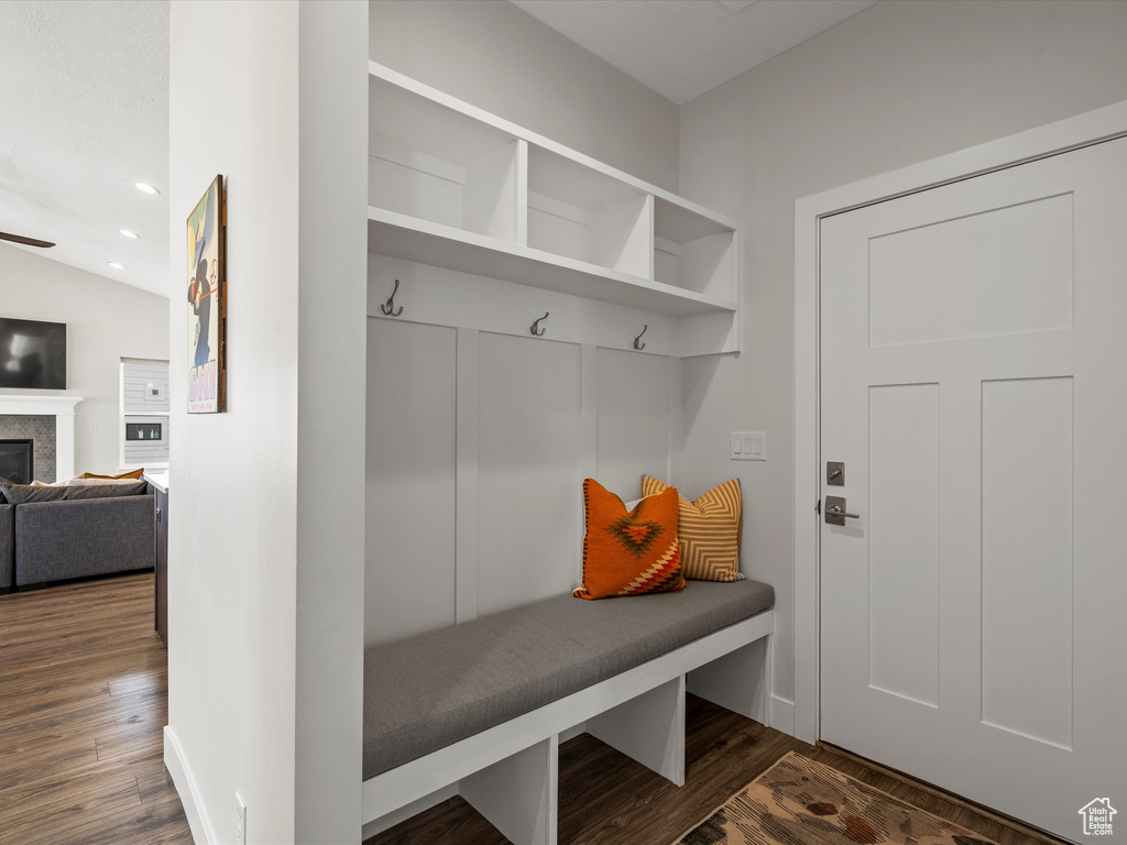 Mudroom with recessed lighting, dark wood-style flooring, and a tile fireplace