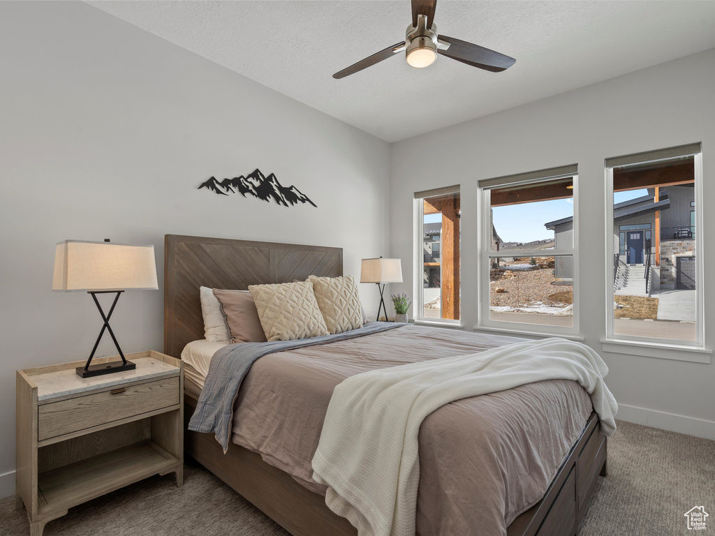 Bedroom with ceiling fan, carpet, and baseboards