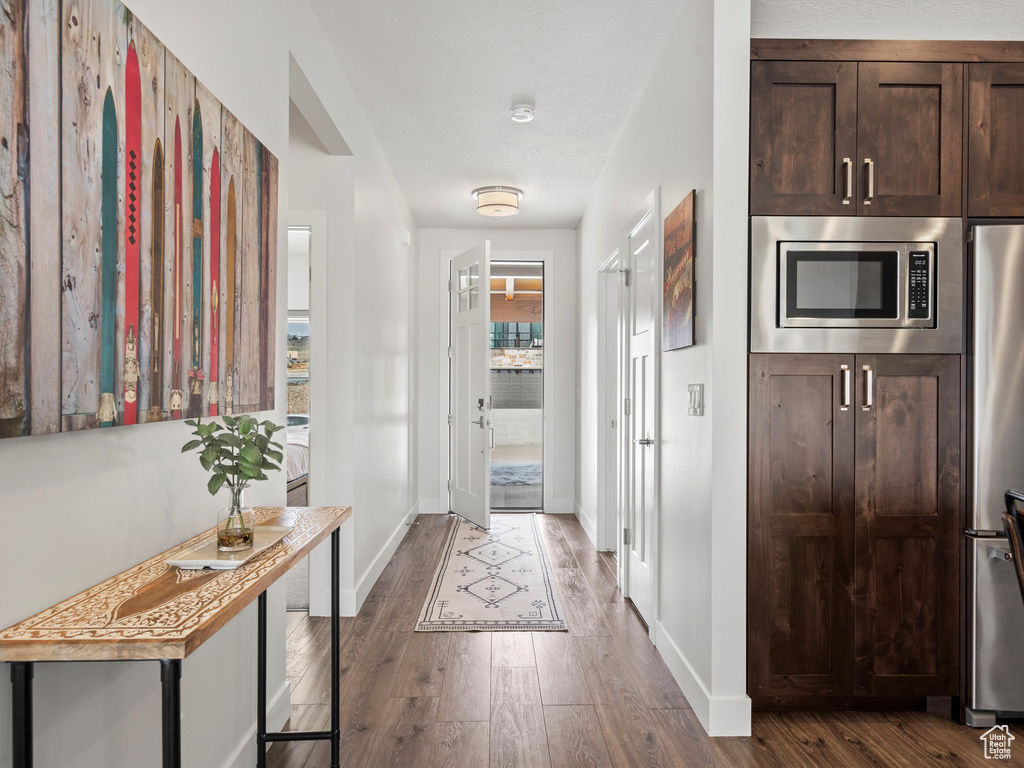 Interior space featuring dark wood-type flooring and baseboards