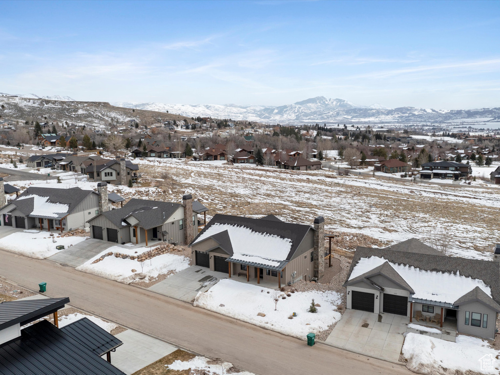 Snowy aerial view featuring a residential view