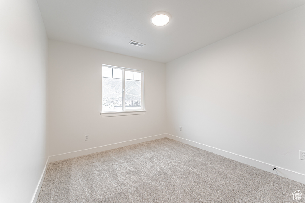 Unfurnished room with carpet floors and baseboards