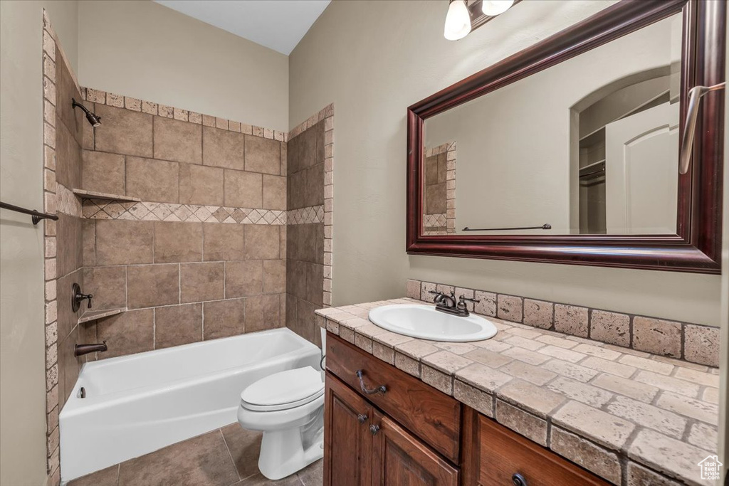 Bathroom featuring vanity, bathing tub / shower combination, and tile patterned flooring