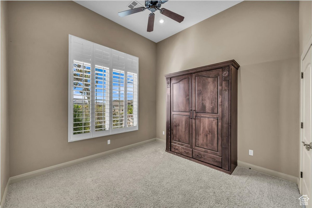Unfurnished bedroom with carpet and ceiling fan
