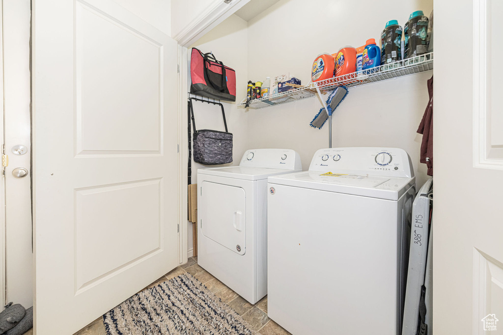 Washroom featuring laundry area and washer and clothes dryer
