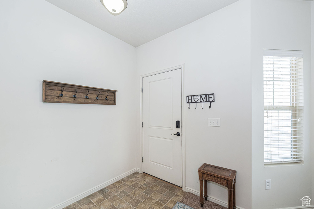 Entryway featuring a wealth of natural light and baseboards