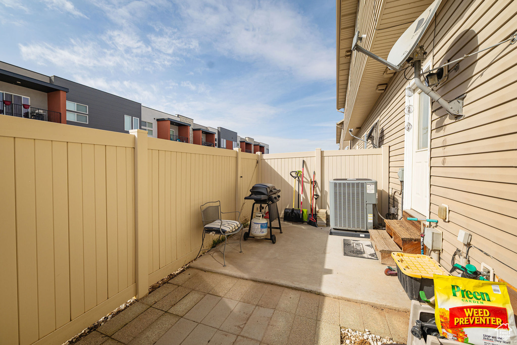 View of patio featuring a fenced backyard and central AC unit