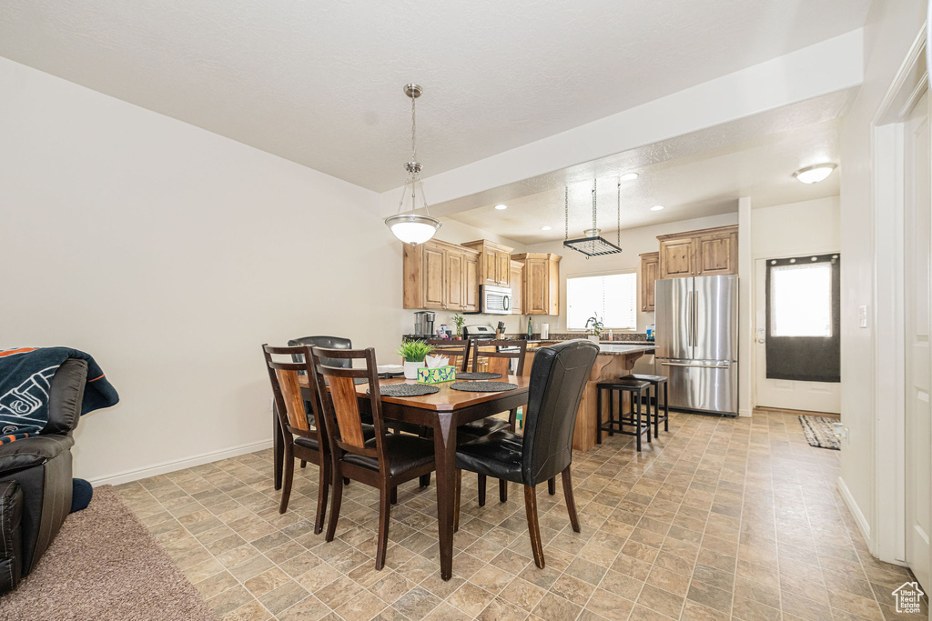 Dining room with recessed lighting and baseboards
