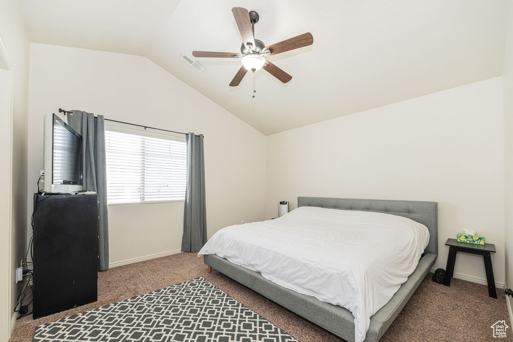 Bedroom featuring visible vents, baseboards, lofted ceiling, ceiling fan, and carpet