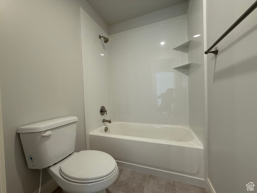 Bathroom featuring toilet and washtub / shower combination