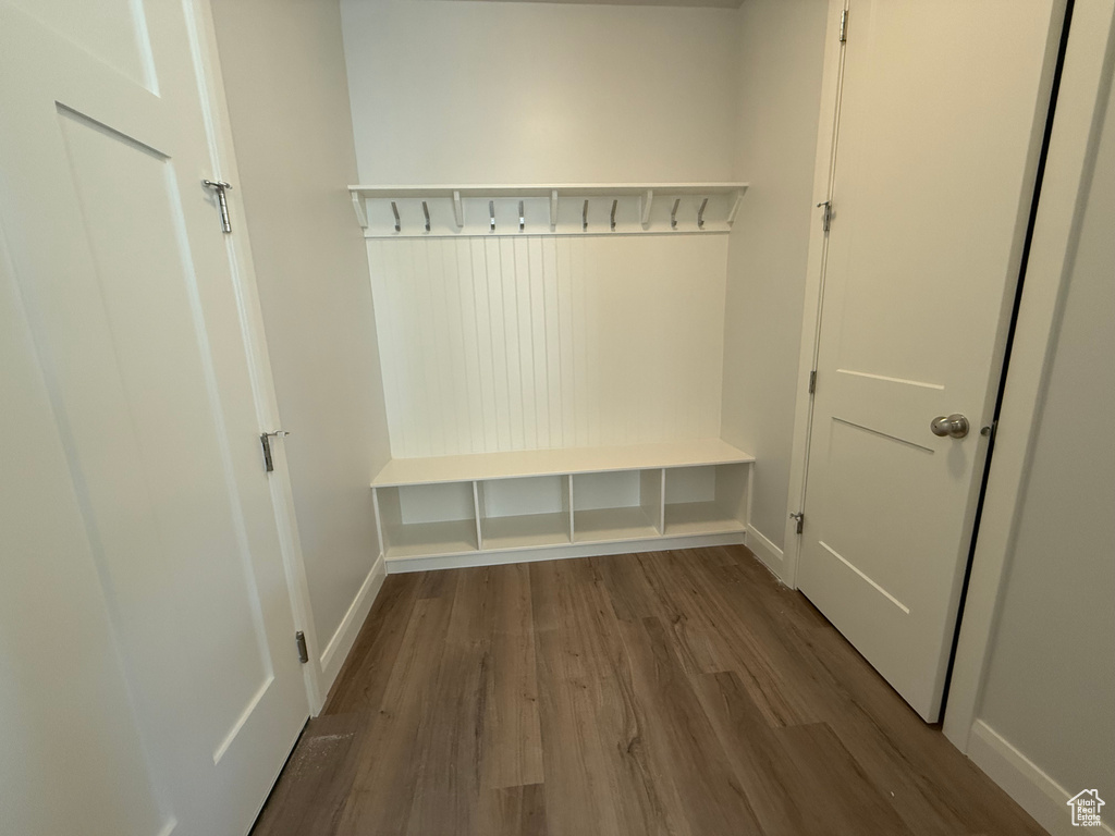 Mudroom featuring wood finished floors and baseboards