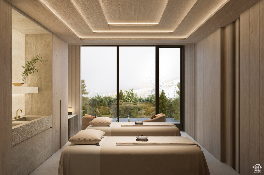 Bedroom featuring a wall of windows, wood ceiling, and a raised ceiling