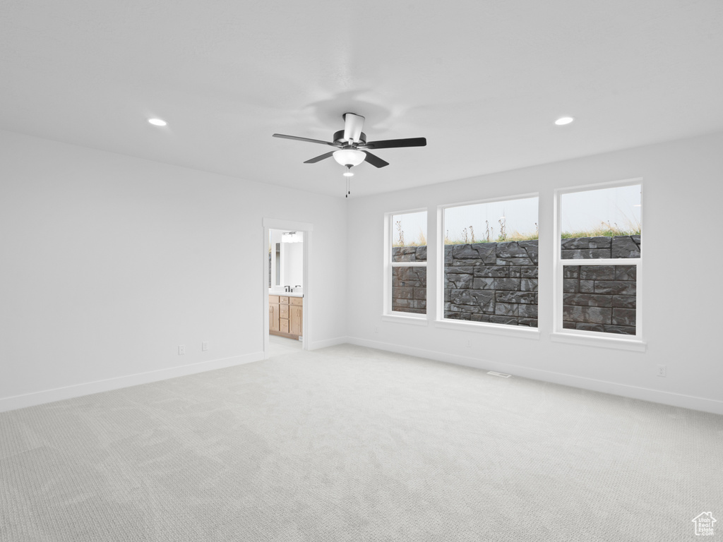 Unfurnished room featuring recessed lighting, light carpet, and baseboards