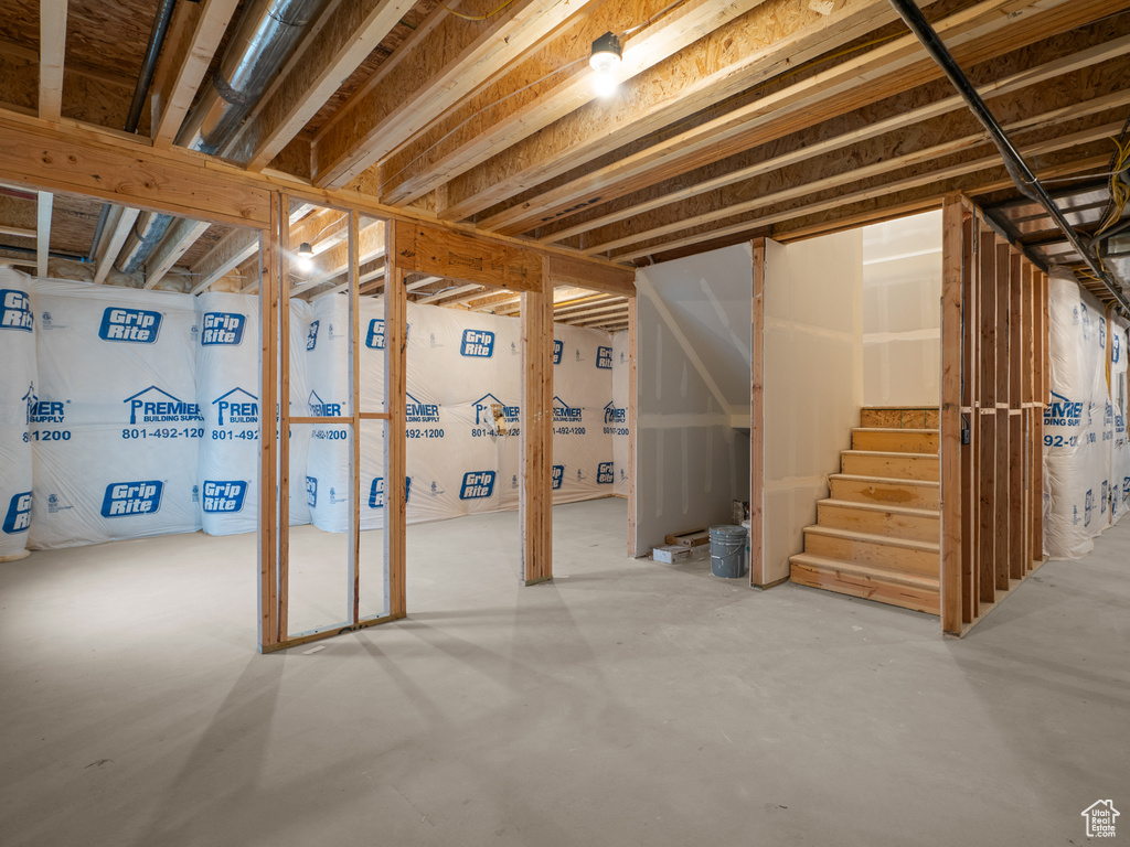Unfinished below grade area featuring stairs