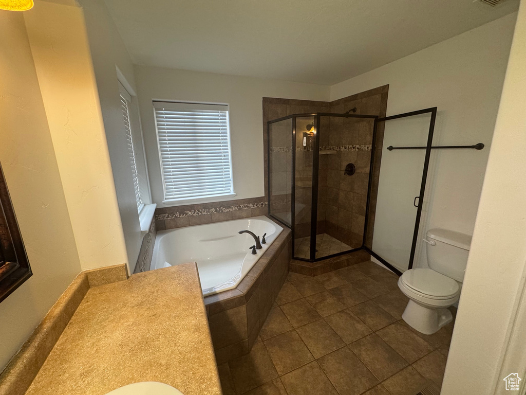 Full bathroom featuring visible vents, toilet, a stall shower, tile patterned flooring, and a bath