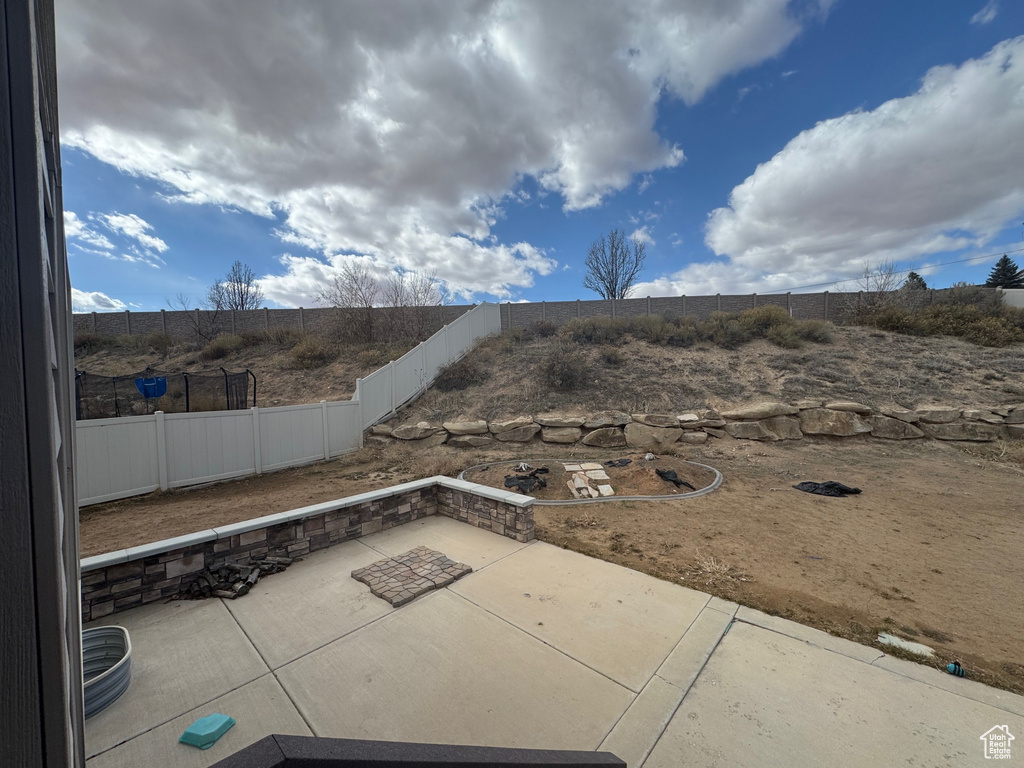 View of patio with a fenced backyard
