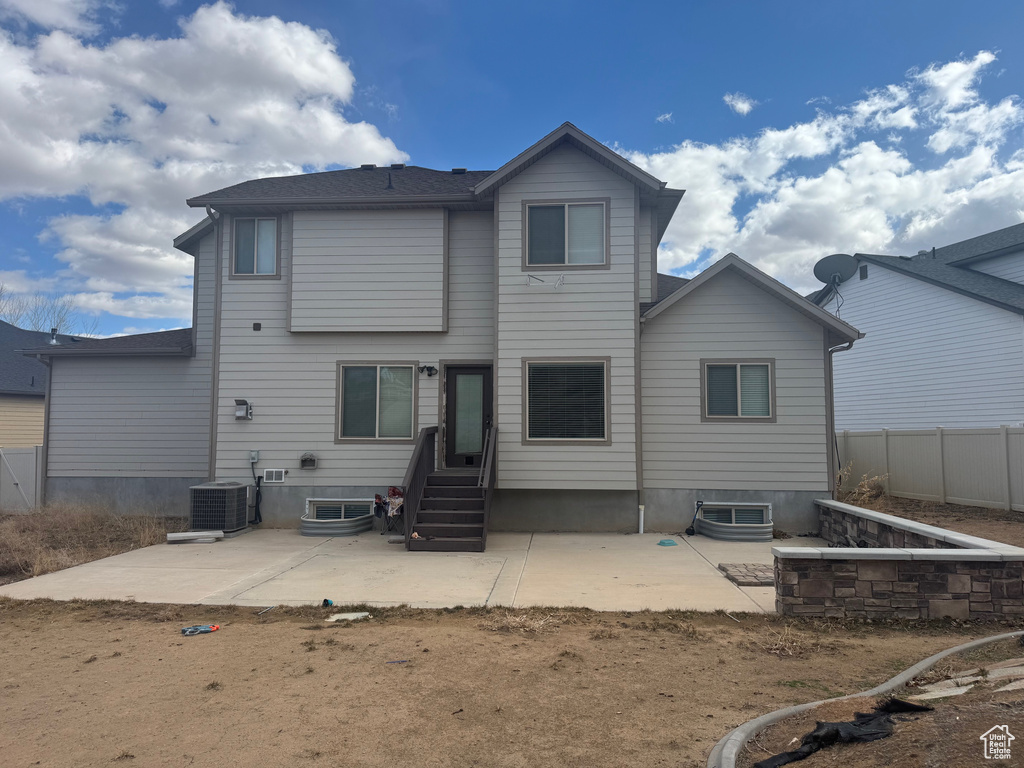 Back of house featuring central air condition unit, a patio, and fence