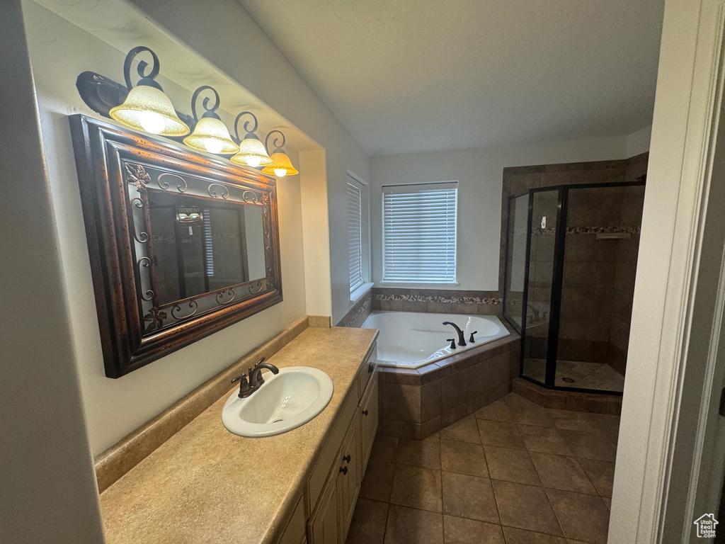 Full bath featuring tile patterned floors, a shower stall, vanity, and a bath