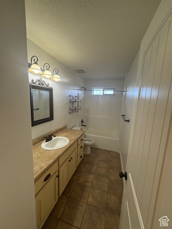 Full bath featuring visible vents, toilet, vanity, shower / tub combination, and a textured ceiling