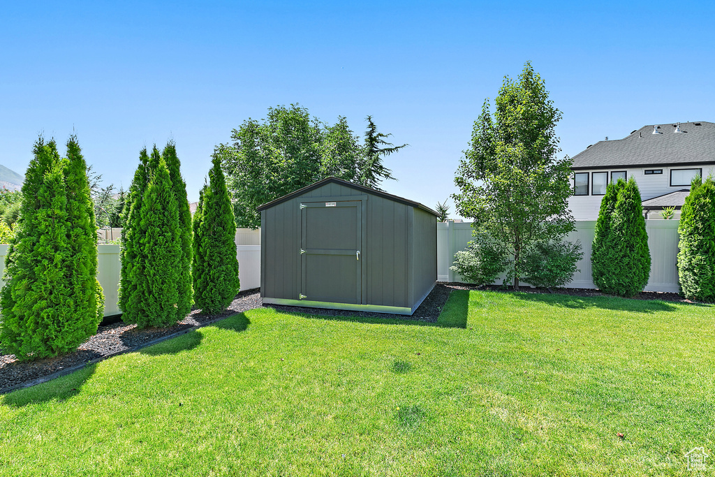 Fenced backyard with a storage shed