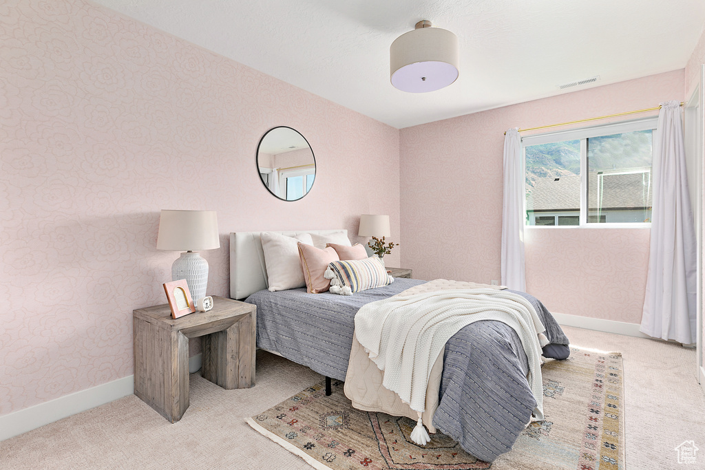 Bedroom featuring carpet flooring and baseboards