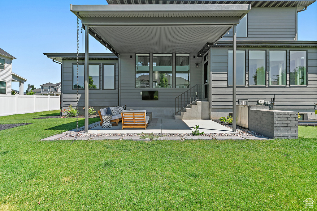 Back of property featuring a patio, entry steps, and outdoor lounge area
