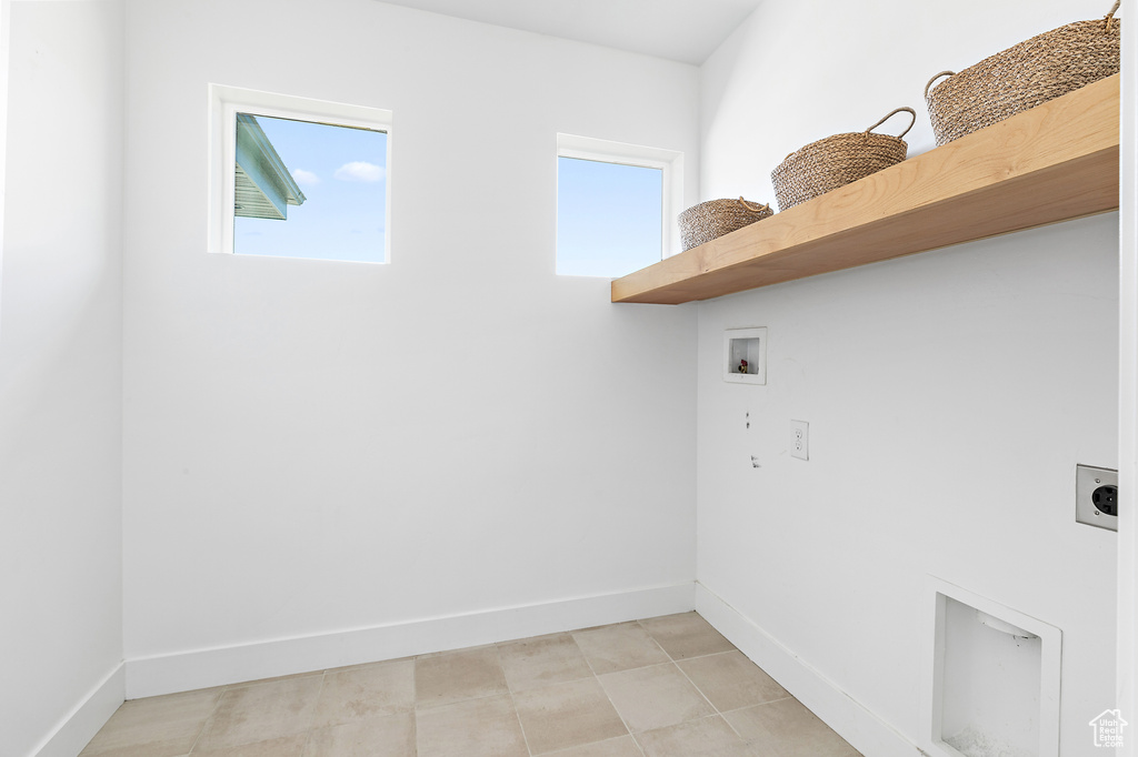Laundry area featuring hookup for an electric dryer, healthy amount of natural light, and hookup for a washing machine