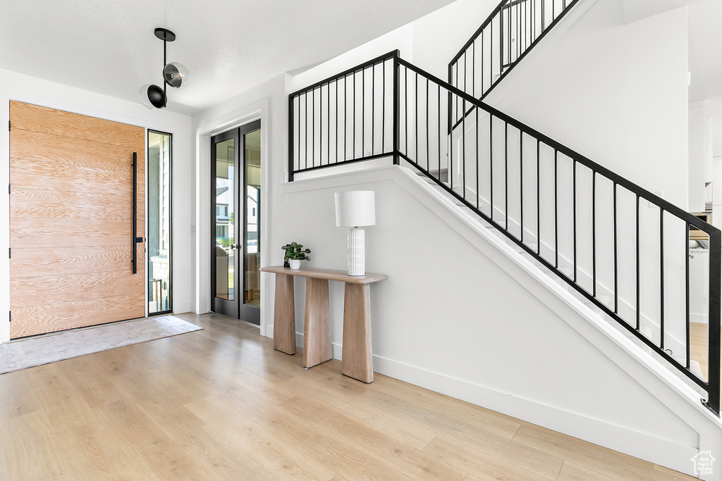 Foyer with wood finished floors and stairway