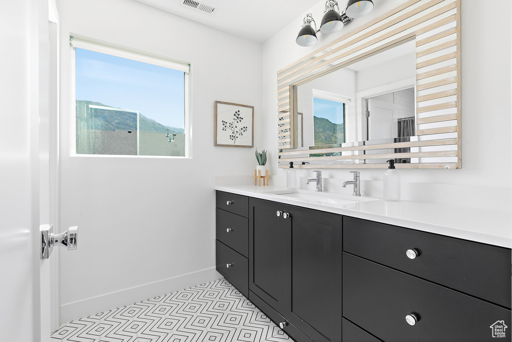 Bathroom with vanity and baseboards