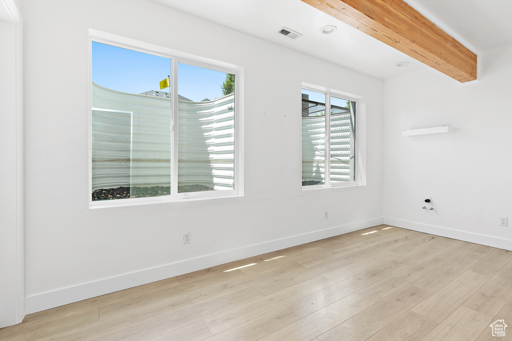Unfurnished room with light wood finished floors and baseboards