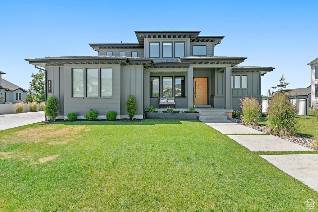 Italianate-style house with board and batten siding and a front lawn