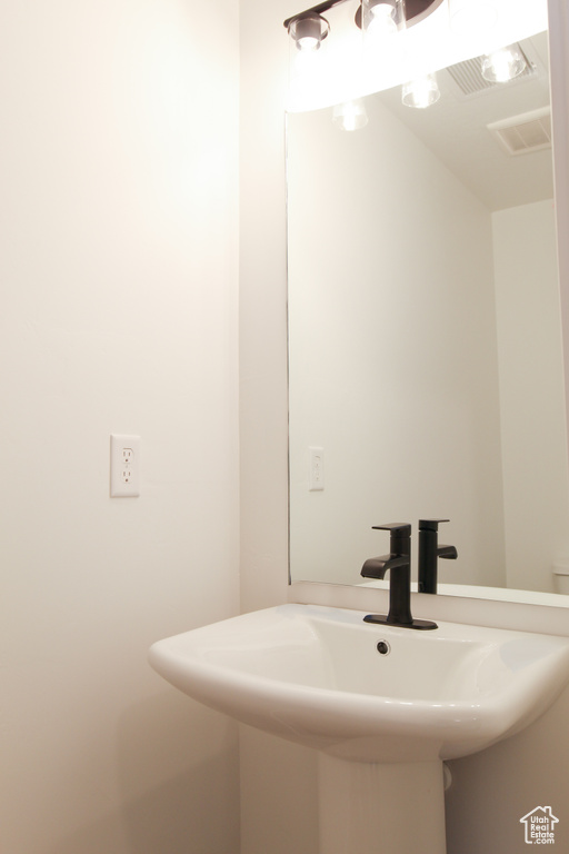 Bathroom with a sink and visible vents