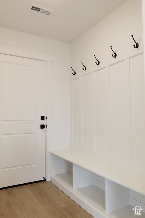 Mudroom with visible vents and light wood finished floors