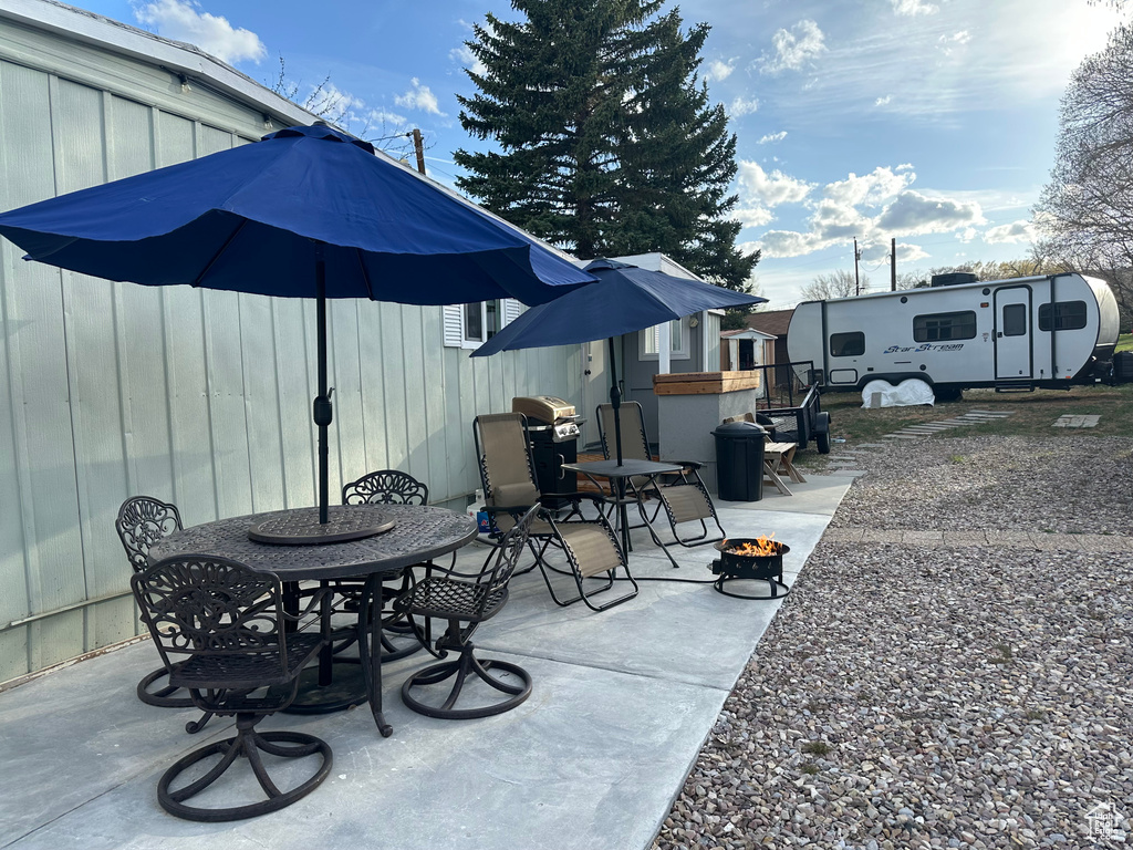 View of patio / terrace with an outdoor fire pit and outdoor dining space