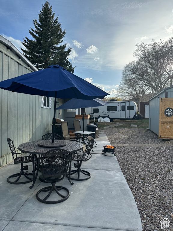 View of patio featuring outdoor dining area and an outdoor structure
