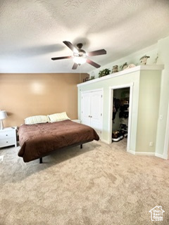 Bedroom with a ceiling fan, carpet, a textured ceiling, and baseboards